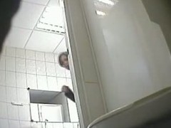 A juicy brunette caught hard by a spy camera pissing not far from a public toilet